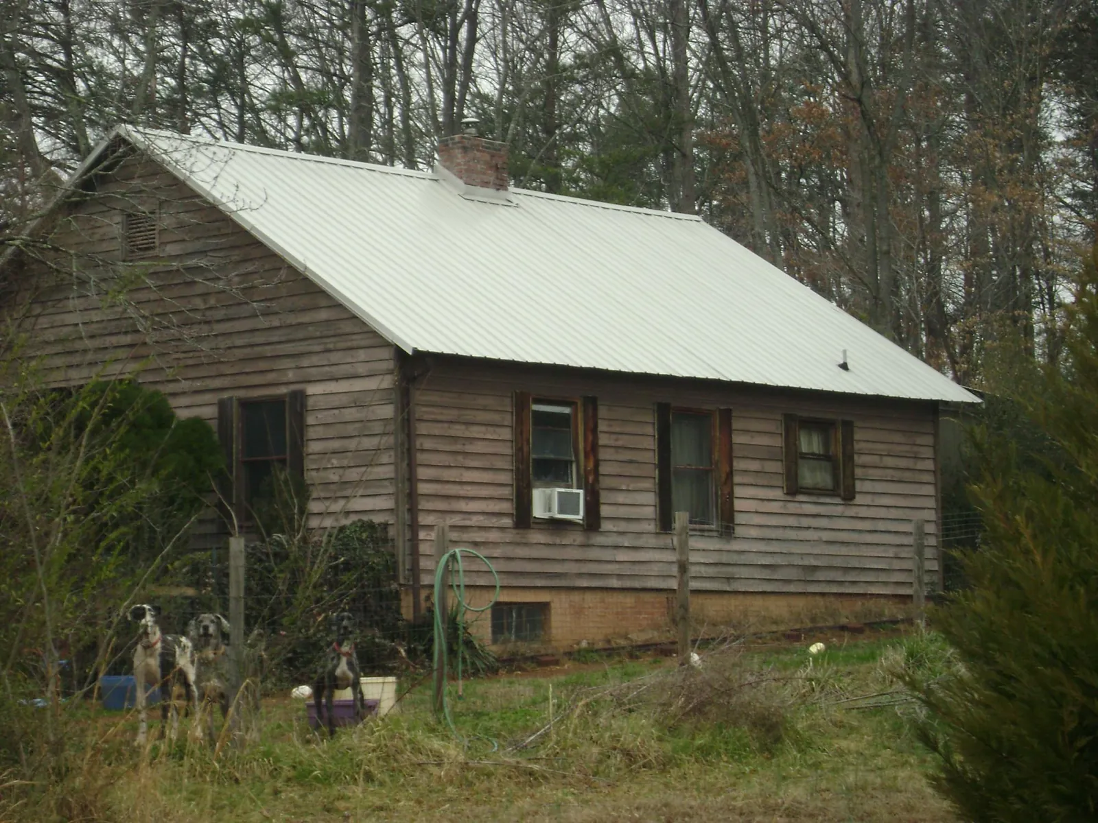 White metal roof on an old wood sided farmhouse, from a Metal Roof Installation job in Keyport